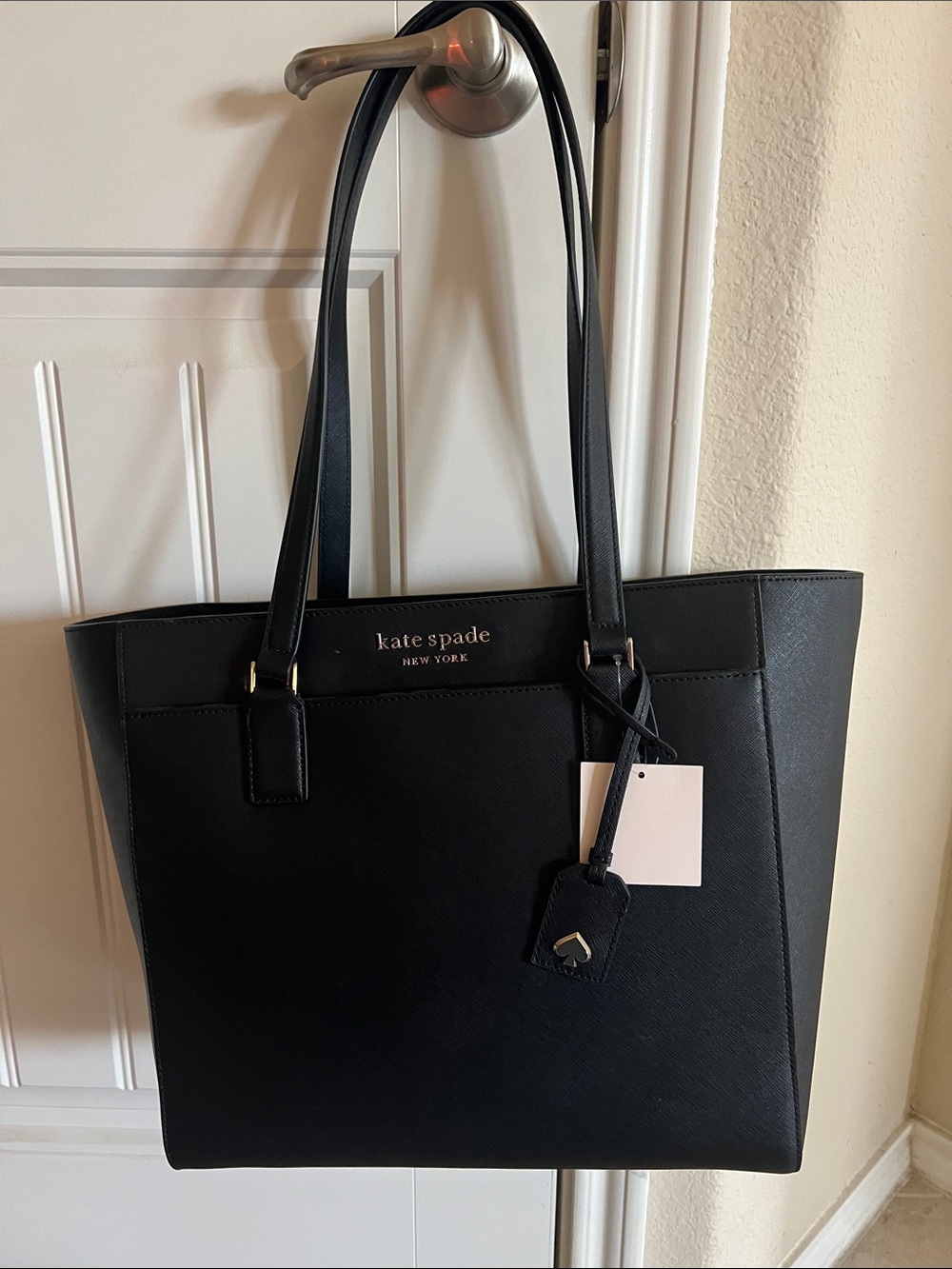 kate spade black leather tote with logo charm